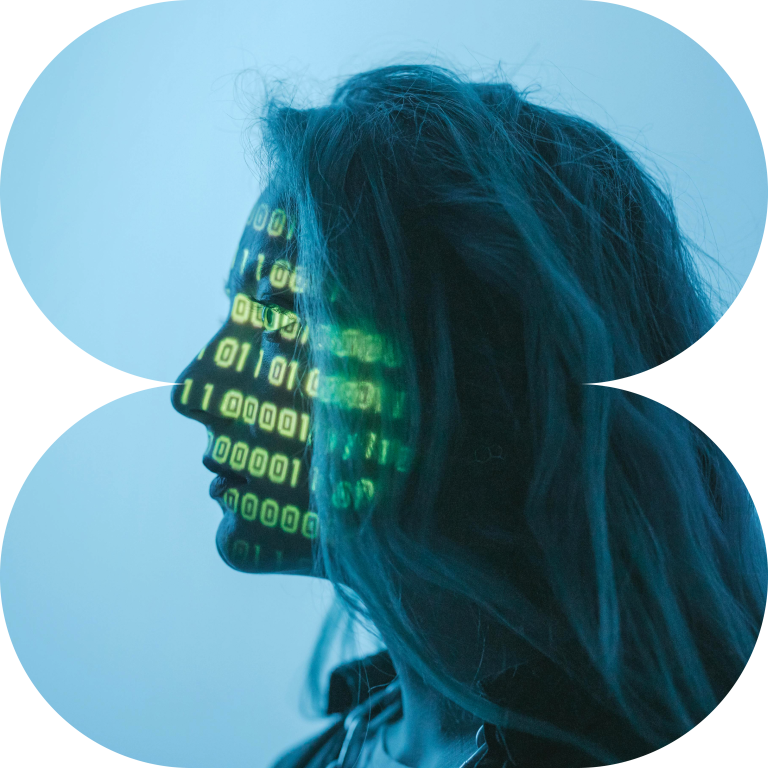 Image of a woman facing left in blue light with binary code projected on the side of the face